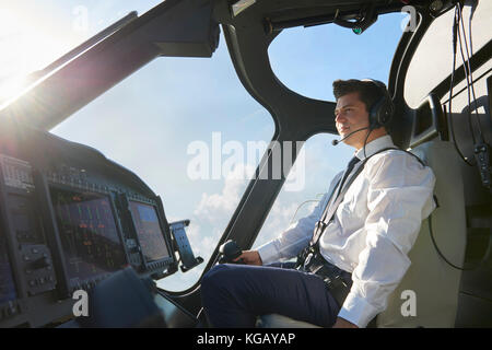 Pilot In Cockpit Of Helicopter During Flight Stock Photo