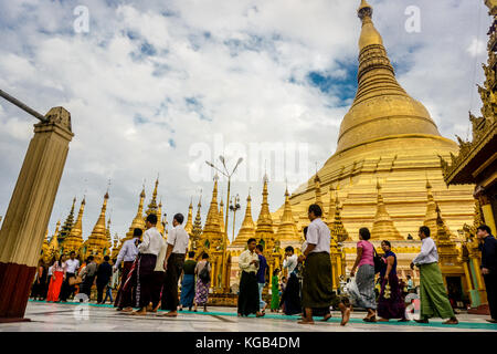 People walking around at Shwedagon Pagoda (officially named Shwedagon Zedi Daw) and also known as the Great Dagon Pagoda.  A  gilded stupa located in  Stock Photo