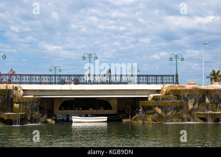 SAMSUN, TURKEY - SEPTEMBER 03, 2016 : General landscape view of small lake with artificial waterfall among bench and seats in natural park on cloudy s Stock Photo