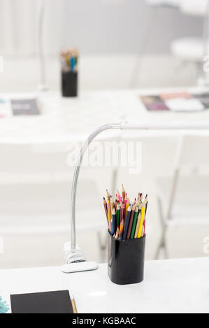 Many crayons with different colors. Back to school. Colored pencils in an glass Stock Photo