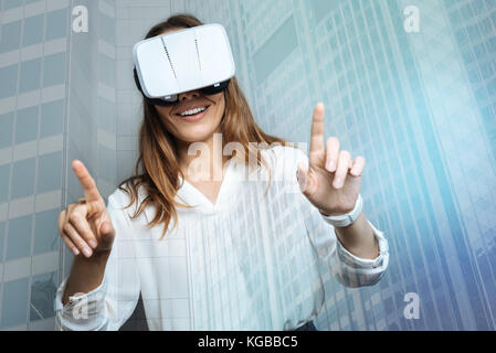 Cheerful delighted woman being in 3d reality Stock Photo