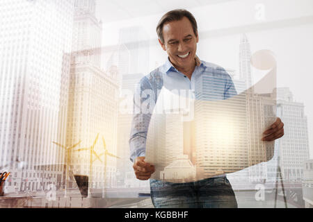 Professional eco engineer holding a blueprint Stock Photo