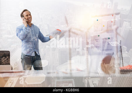 Joyful senior eco engineer talking on phone Stock Photo