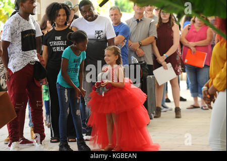 Orlando, United States. 05th Nov, 2017. November 5, 2017- Orlando, Florida, United States- Singer Valerie Domovsky (wearing red dress) holds a stuffed animal toy while waiting in line at the season 12 open call auditions for NBC's 'America's Got Talent' television show on November 5, 2017 at the Orange County Convention Center in Orlando, Florida. Orlando is the first of 10 American cities where auditions are scheduled. Credit: Paul Hennessy/Alamy Live News Stock Photo