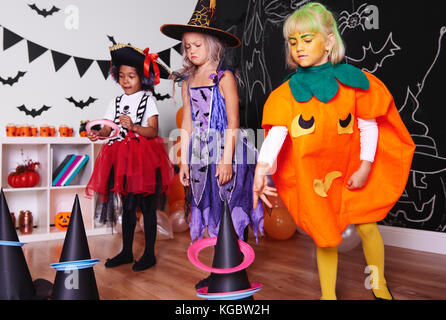 Children actively spending time at Halloween party Stock Photo