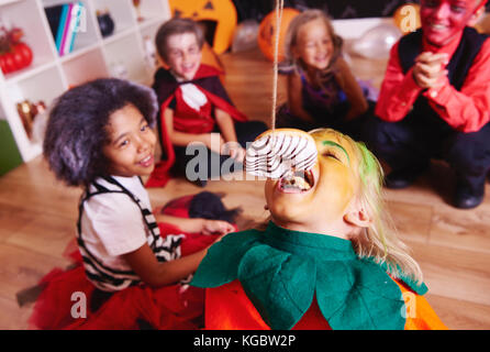 Children enjoying at halloween party Stock Photo
