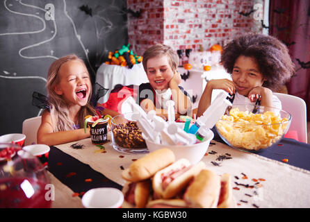 Kids in halloween costumes having a snack Stock Photo