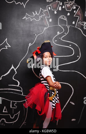 Mixed race girl in pirate costume Stock Photo