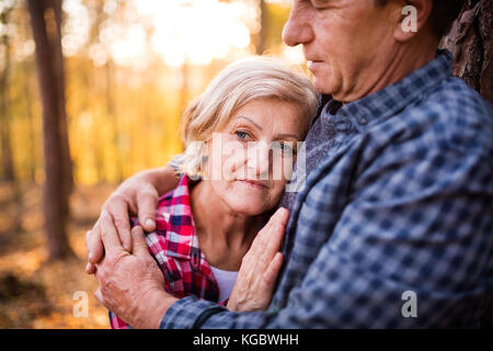Senior couple on a walk in an autumn forest. Stock Photo