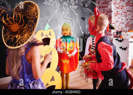 Children celebrating halloween at home Stock Photo