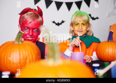 Painting a pumpkin is their favourite part of Halloween Stock Photo
