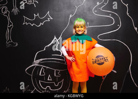 Happy girl in pumpkin costume Stock Photo