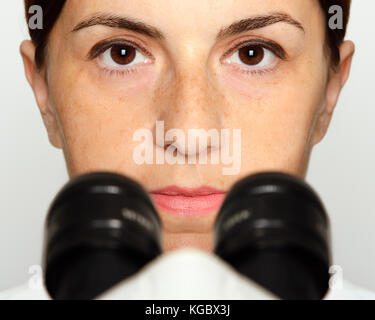 Scientist with a Microscope, Close Up. Stock Photo