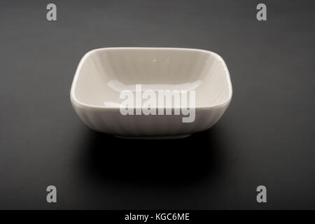 square shape empty ceramic dish on a black background Stock Photo