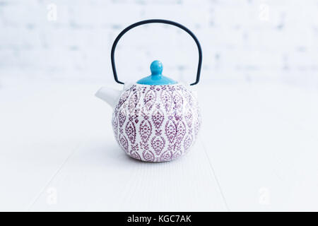Elegant Chinese style tea pot with a beautiful pattern on white background. Stock Photo