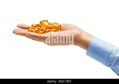 Man's hand in shirt holds many capsules Omega 3 isolated on white background. Close up. High resolution product. Health care concept Stock Photo