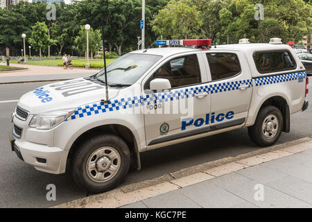 Sydney, Australia - March 23, 2017: Closeup of white and blue police SUV car of canine unit parked on side of Saint Marys Cathedral. Park in backgroun Stock Photo