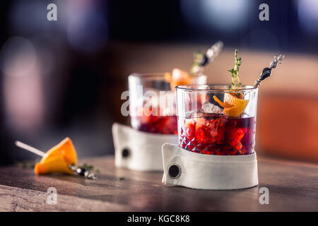 Fresh cocktail drink with ice fruit and herb decoration. Alcoholic, non-alcoholic drink-beverage at the bar counter in the pub restaurant  or night cl Stock Photo