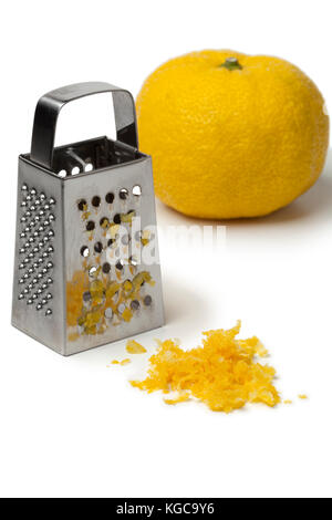 Fresh zest of a yellow Japanese Yuzu and grater on white background Stock Photo