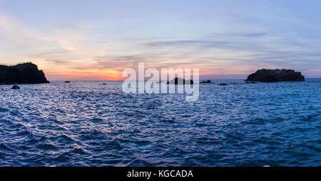 Sunset relecting in the choppy waters at Hartland Quay in North Devon, England. Stock Photo