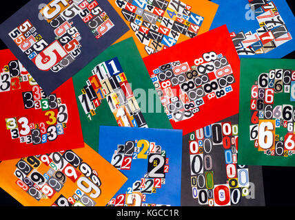 Ten numbers made from numbers cutting from magazines on black background. Close-up. Stock Photo