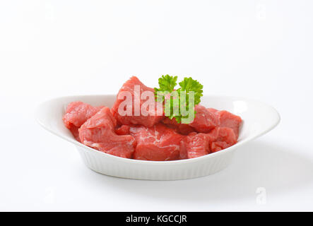 bowl of diced raw beef meat on white background Stock Photo