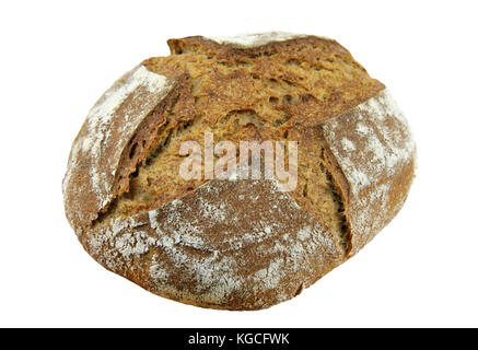 Crusty homemade artisan round wholemeal or whole wheat sourdough bread loaf made from natural wild yeast sourdough starter culture. Isolated image. Stock Photo
