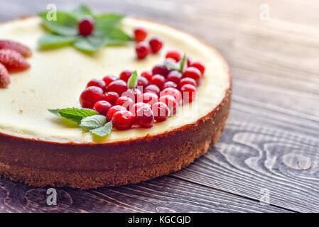 Fresh cheesecake with berries on a wooden background. Stock Photo