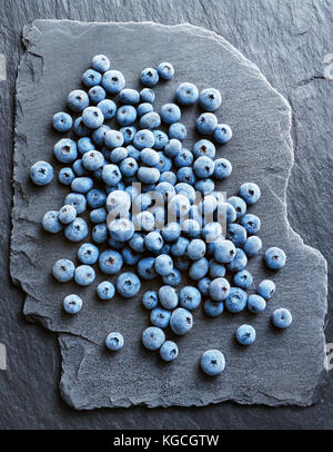 Frozen blueberry on black slate. Top view. High resolution product. Stock Photo
