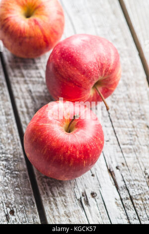 Fresh red apples on old wooden table. Stock Photo