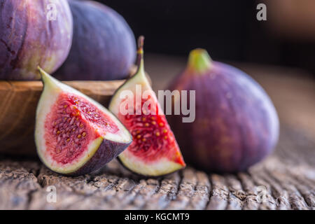 Figs. A few figs in a bowl on an old wooden background. Stock Photo