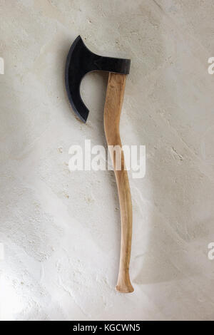 Ancient battle axe on the stone background white wall. With clipping path Stock Photo