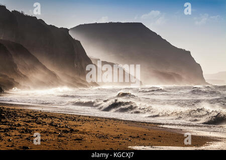 Sunrise on Charmouth beach looking towards Golden Cap. Stock Photo