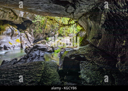 Atluck Creek cutting through the cast limestone creating Huson Natural Bridge Cave in Little Huson Cave Regional Park, Northern Vancouver Island, Brit Stock Photo