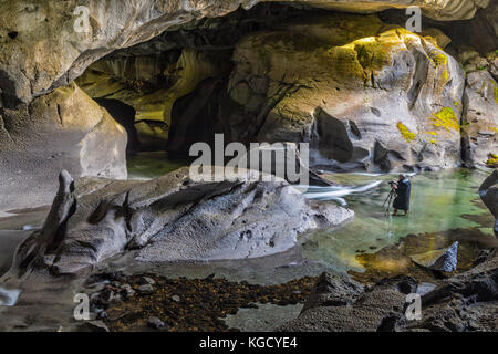 Bob photographing during a photography workshop with Rolf Hicker in little Huson Cave Regional Park, Northern Vancouver Island, British Columbia, Cana Stock Photo