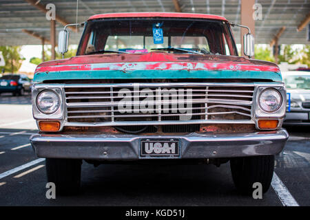 Old beat up van in a parking lot. Stock Photo