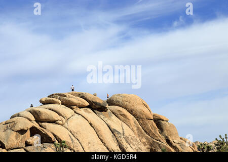 People on top of huge rock at Joshua tree national park Stock Photo