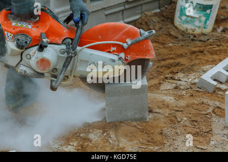 grinder worker cuts a stone the electric tool Stock Photo