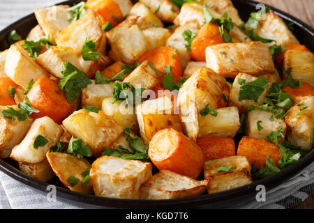 Baked celery root and carrot macro on a plate. horizontal Stock Photo
