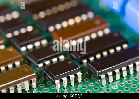Rows of integral circuits on Printed Circuit Board close-up Stock Photo