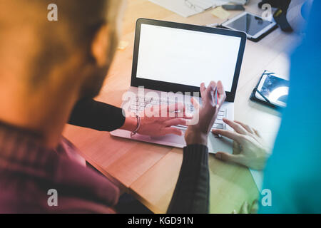 Close up on the hand of business people typing on the keyboard of a modern notebook  - technology, business, working concept Stock Photo