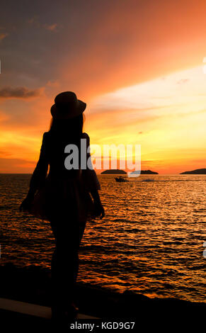silhouette of a woman under beautiful sunset Stock Photo - Alamy