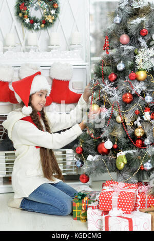 Girl decorating Christmas tree Stock Photo