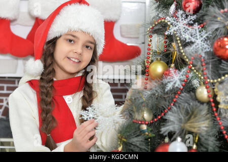 Girl decorating Christmas tree Stock Photo