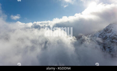 Cloud On Ridges Aerial view of clouds circling around mountain ridge Stock Photo - Alamy
