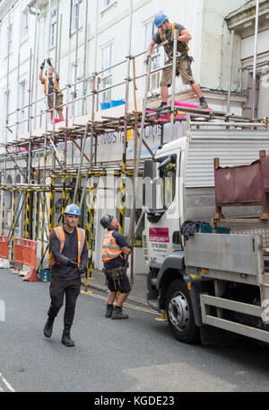 Construction workers dismantling scaffolding Stock Photo - Alamy