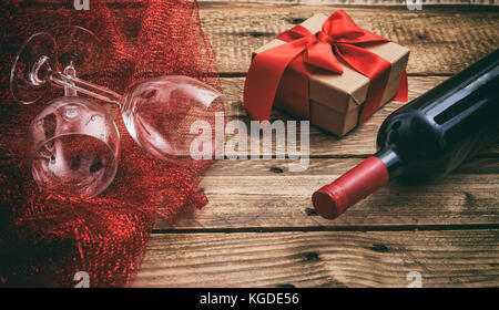 Valentines day concept. Red wine bottle and glasses on wooden background Stock Photo