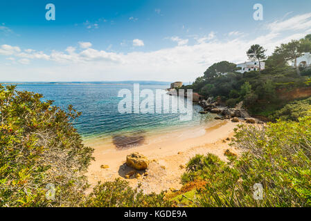 Golden sand in a small cove in Alghero Stock Photo