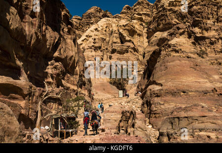 Tourists walking up steps and riding horses and donkeys, route to Ad Deir, the Monastery, Petra, Jordan, Middle East Stock Photo