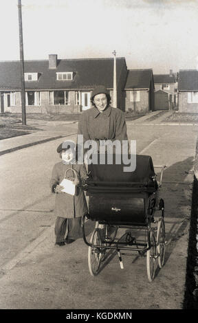 1955 historical mother out walking near her home with her young daughter and pushing a coachbuilt Pedigree pram a well made and popular brand of this era Stock Photo Alamy